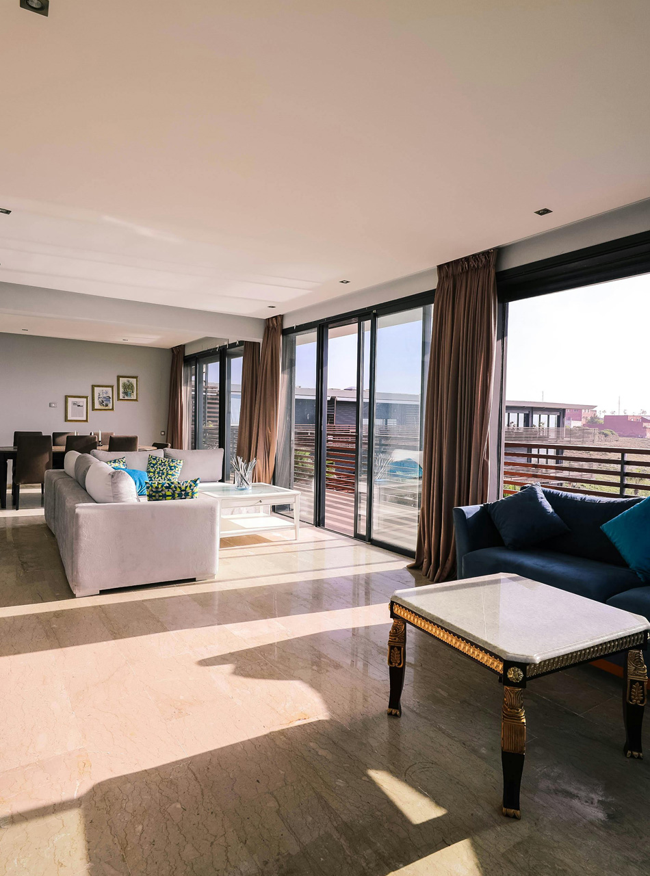 Spacious modern apartment living room with large windows and natural light, highlighting multifamily housing interiors.